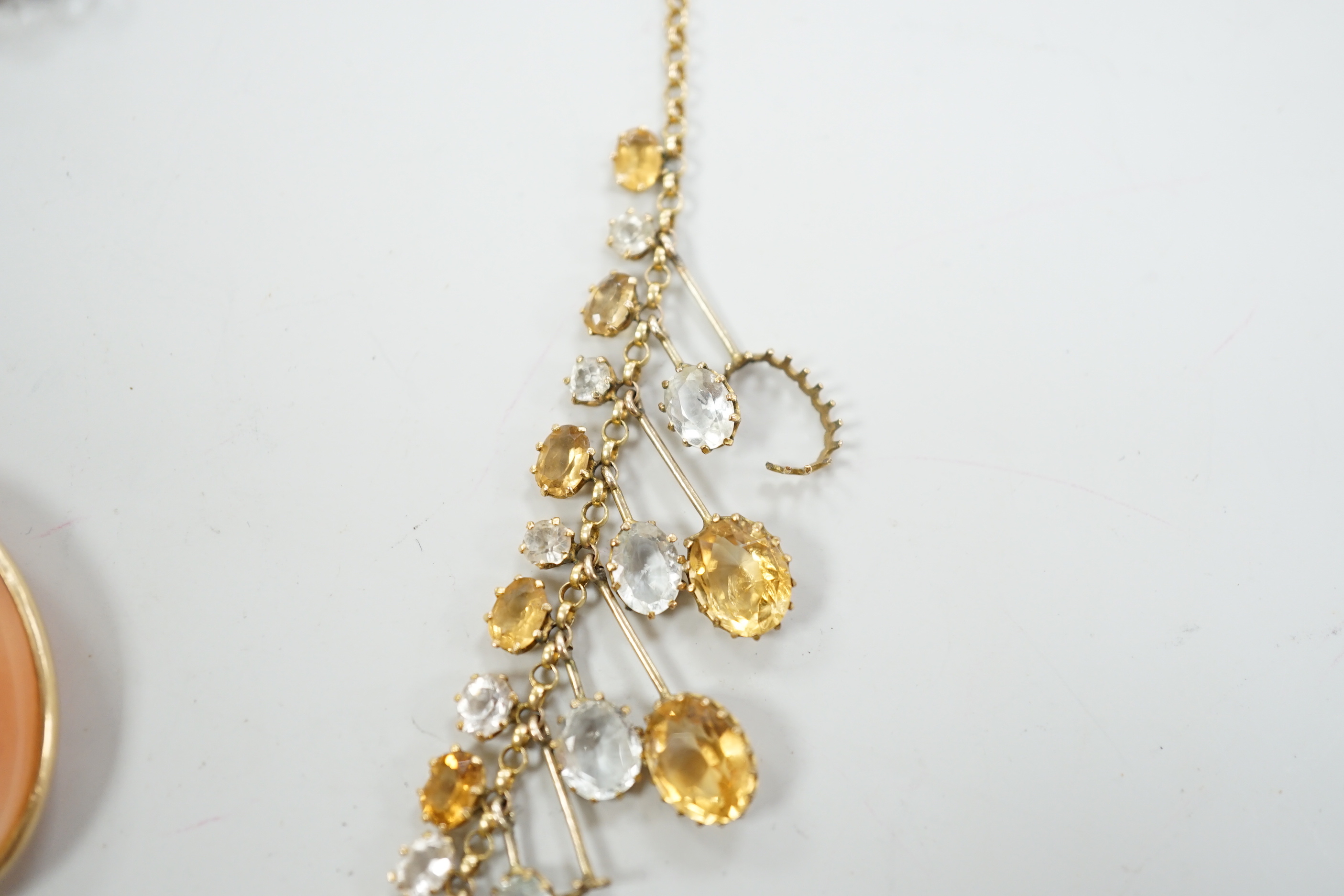A yellow metal mounted oval cameo shell pendant, on a 9ct chain, together with a citrine and colourless beryl? set drop fringe necklace(a.f.).